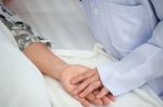 Close-up Doctor Take Care Hold Hand Patient Grandmother Sleep In Elderly Home Stock Photo