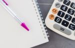 Calculator, Notepad And Pen On Grey Background Stock Photo