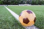 Wooden Football Lying On Sideline On Football Field Stock Photo