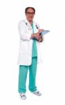 Aged Doctor Holding Clipboard Stock Photo