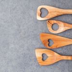 Various Wooden Cooking Utensils Border. Wooden Spoons And Wooden Stock Photo