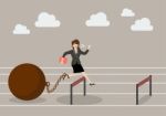 Business Woman Jumping Over Hurdle With The Weight Stock Photo