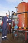 Engineer Working With Oil Refinery Stock Photo