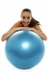 Woman Leaning Over Big Blue Swiss Ball Stock Photo