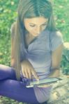 Beautiful Woman With Tablet Computer In Park Stock Photo