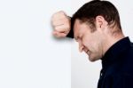 Unhappy Man Leaning At The Wall Stock Photo