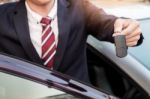 Young Successful Businessman Offering A Car Key. Close-up Of Dri Stock Photo