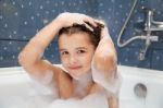 Little Girl Washes Her Head In The Bath Stock Photo