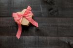 Gift  With A Red And White Bow On Wooden Background Stock Photo