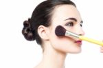 Woman Applying Make Up With Brush Stock Photo