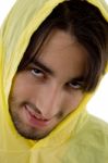 Young Man In Yellow Raincoat Stock Photo