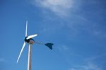 Green Renewable Energy Concept - Wind Generator Turbines On Blue Stock Photo