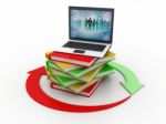 A Laptop With Books Stock Photo