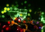 Two Glasses Of Champagne With A Christmas Decoration In The Background Stock Photo