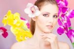 Pretty Woman In Front Of  Flowers Stock Photo