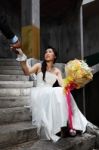 Urban Bride Holding Grooms Hand Stock Photo