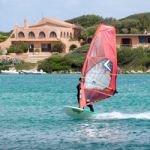 Porto Pollo, Sardinia/italy - May 21 : Windsurfing At Porto Poll Stock Photo