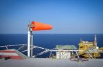 The Wind Sock Is Set On The Oil Rig To Showing Wind Direction Fo Stock Photo