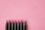 Pink, Red And Violet Tone Colour Of Black Pencils On Pastel Pink Stock Photo