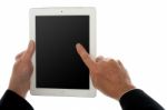 Finger Of A Man On Tablet Pc Screen, Closeup Shot Stock Photo