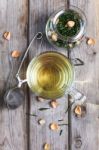 Mug Of Flavored Green Tea With Rose Buds And Petals Stock Photo