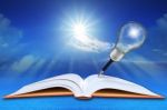 Open Book On Sea And Blue Sky With Pencil Light Bulb Stock Photo