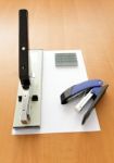 Big And Small Staplers With Staples And Paper On The Table Stock Photo