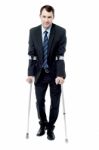Smart Man With Crutches Trying To Walk Stock Photo