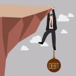 Businessman Try Hard To Hold On The Cliff With Debt Burden Stock Photo