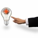 Hand Of Business Man Pointing To Light Bulb With Red Smart Brain Stock Photo