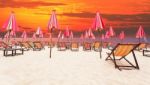 Wood Chairs On Sea Beach With Dramatic Sky Background Stock Photo