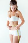 Young Woman Measuring Her Waist By Measure Tape Stock Photo