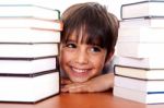 Young Kid Relaxing Between Pile Of Books Stock Photo