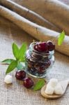 Red Cherries In Glass Jar Stock Photo