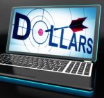 Dollars On Laptop Shows Financial Currencies Stock Photo