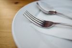 Fork And Spoon With White Plate On Wood Table Stock Photo