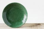 Green Plate On Wooden Stock Photo