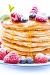 Pile Of Pancakes With Blueberries And Raspberries Sprinkled With Stock Photo