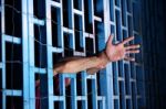 Hands Of Prisoner In Jail As Background Stock Photo
