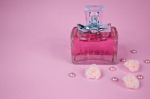 Pink Perfume With Pink Pearls And Pink Textile Roses On Pink Background Stock Photo