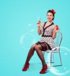 Young Woman Blowing Bubbles Indoor Stock Photo