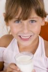 Smiling Girl With Glass Of Milk Looking You Stock Photo