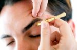 Man Removing Eyebrow Hairs With Tweezing Stock Photo