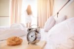 Woman Stretched In Bed Room After The Alarm Clock And Bread In T Stock Photo