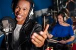 Young Man Singing In Studio Stock Photo
