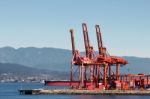 Red Cranes In Vancouver Harbour Stock Photo