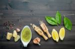 The Ingredients For Green Pesto Sauce On Dark Wooden Background Stock Photo