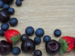 Fresh Summer Fruits, Cherry, Strawberry And Blueberry On Wood Ba Stock Photo