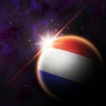 Netherlands Flag On 3d Football With Rising Sun Stock Photo