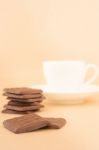 White Mug Of Hot Coffee And Chocolate Pieces Stock Photo